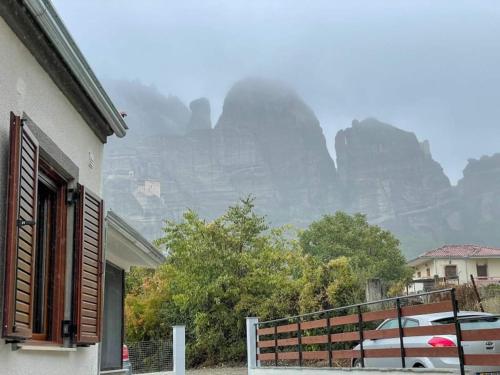 a car parked in front of a house with a mountain at Paradise of Meteora A in Kastrákion