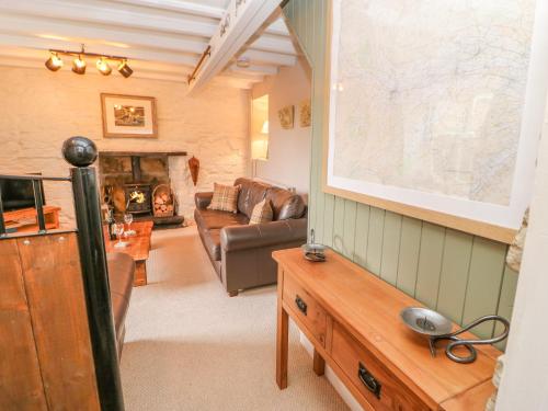 a living room with a couch and a fireplace at High House in Hawes