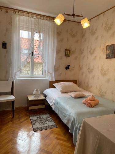 a bedroom with two beds and a window at Soul Apartment in Center in Split