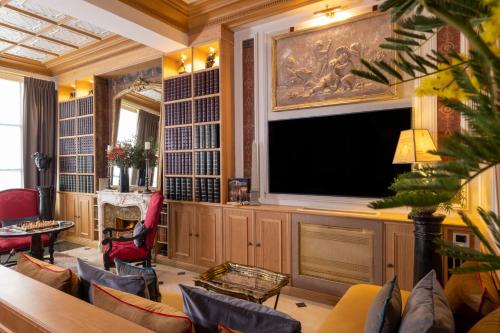 a living room with a large flat screen tv at Maison Cardinal Furstemberg in Paris