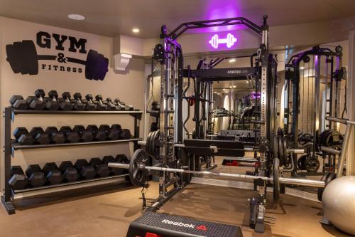 a gym with dumbbells and other equipment at Maison Cardinal Furstemberg in Paris