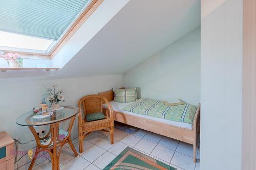 a small bedroom with a bed and a table at Ferienwohnung Hörning in Roxheim