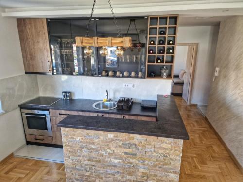 a kitchen with a sink and a counter top at Apartman Dionis in Užice