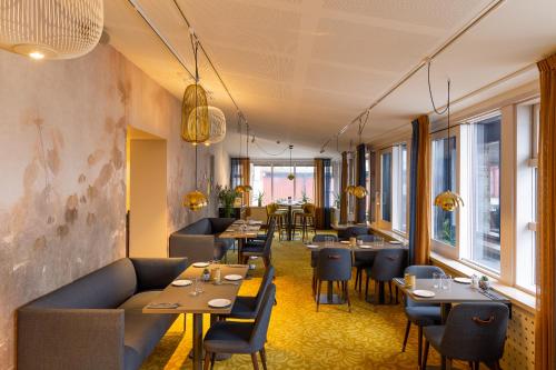 a living room filled with tables and chairs at Dockyard Hotel in Gothenburg
