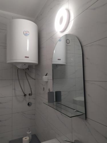 a bathroom with a mirror and a sink at Kuća Mitića in Pirot