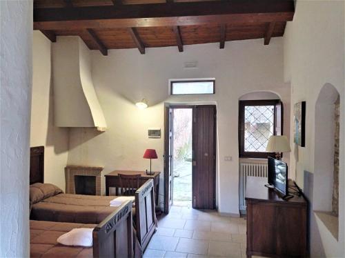 a bedroom with a bed and a tv in a room at Case Vacanza Al Borgo Antico in Vico del Gargano