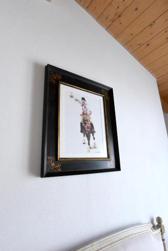 a picture of a man on a horse on a wall at La Dimora di San Simplicio in Olbia