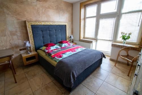 a bedroom with a large bed with red pillows at Apartamenty Gdynia City Center in Gdynia