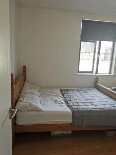 a bed in a room with a window at Central Spacious Apartment w/ Balcony & City View in Dublin