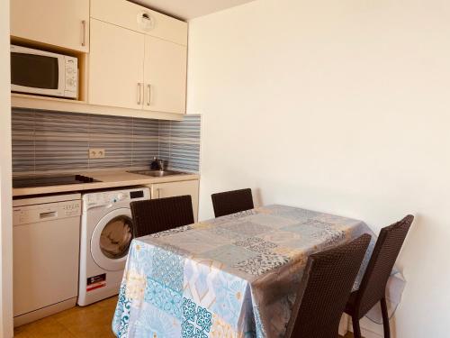 a kitchen with a table with chairs and a microwave at Sunny Home Costa Plana-Monaco -Cap D'Ail in Cap d'Ail
