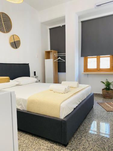 a bedroom with two beds in a room at Homdwell Fine Living 2 in Ermoupoli