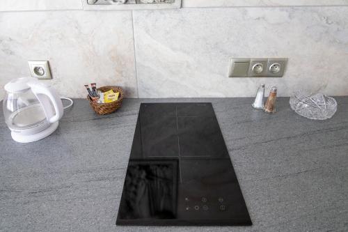 a bathroom with a black counter top and a toilet at Apartamenty Gdynia City Center in Gdynia