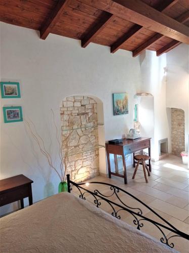 a bedroom with a bed and a stone fireplace at Case Vacanza Al Borgo Antico in Vico del Gargano