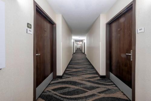 a corridor with doors and a carpeted hallway at Red Roof Inn Dahlgren - Naval Base in Dahlgren