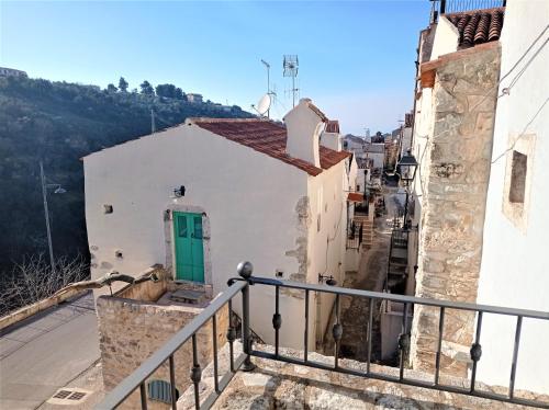 a view from a balcony of a white building with a green door at Case Vacanza Al Borgo Antico in Vico del Gargano
