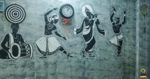 a wall with paintings of people on it at Yaarl Hostels in Jaffna