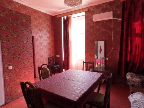 a dining room with a table and chairs and a window at Sabir's Apartment Old Town in Tbilisi City