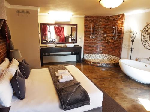 a large bathroom with a tub and a sink at Accolades Boutique Venue in Midrand