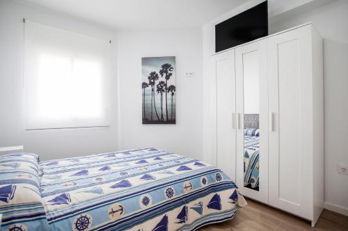 Llit o llits en una habitació de Ático con espectacular terraza y vistas al mar
