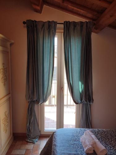 a bedroom with a bed and a sliding glass door at Casa Aurora in Ravenna