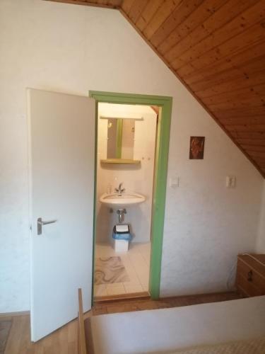 a bathroom with a sink and a mirror at Pálinkás jó reggelt! in Hévíz