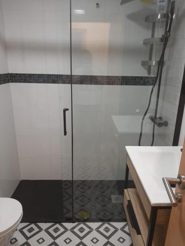 a bathroom with a shower with a toilet and a sink at Appartement ALFONSO in Salou