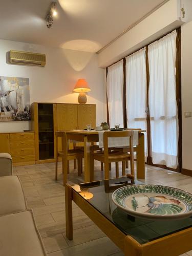 a living room with a table and a couch at Love Italy Homes - Casa Lucia - Residence al Lago in Paratico