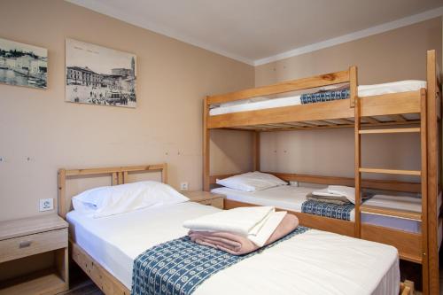 two beds in a room with two bunk beds at Hostel Adriatic Piran in Piran