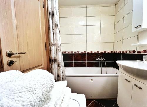 a bathroom with a toilet and a tub and a sink at Adriatique Apartments in Dobra Voda