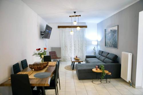 a living room with a couch and a table at Angelina’s Boutique Suite in Nafplio City in Nafplio