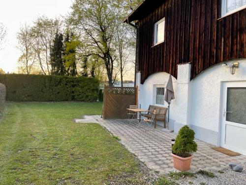 eine Terrasse mit einem Tisch neben einem Haus in der Unterkunft Ferienwohnung Einzimmerappartement in Freilassing