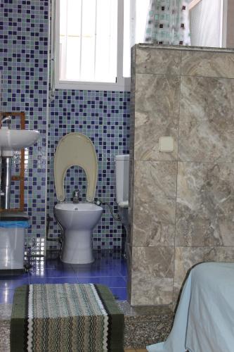 a bathroom with a toilet and a sink at Central Station Hostel Barcelona in Barcelona