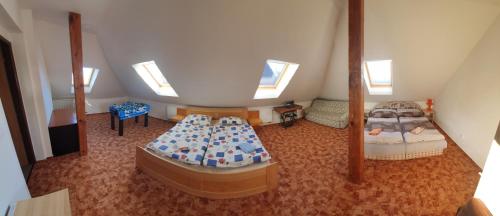 a room with two beds in a attic at Holiday Home U Čápů in Klec