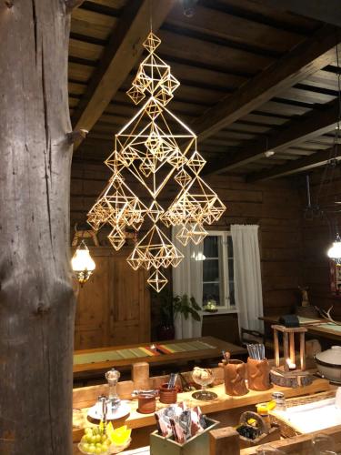 a chandelier hanging over a table in a room at Bear Manor B&B in Kannonkoski