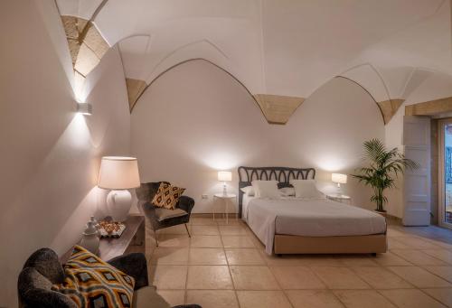 a large bedroom with a bed and a chair at B&B Corte Dei Romiti - Suites & Apartments SIT in Lecce