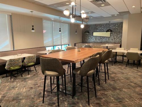 a conference room with a wooden table and chairs at Holiday Inn Martinsburg by IHG in Martinsburg