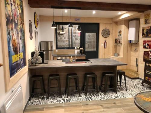 a kitchen with a large island with bar stools at Suite de charme au pied de la cathédrale in Laon