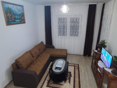a living room with a couch and a tv at Apartment Sailor in Žabljak