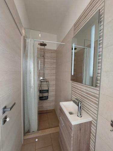 a bathroom with a sink and a shower at Family apartment Cathy in Galižana