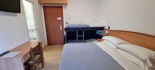 a small room with a bed and a tv at Hotel Mare Blu -- boutique in Pineto