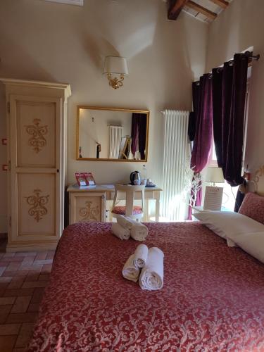 a bedroom with a large bed with towels on it at Casa Aurora in Ravenna