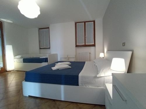 a bedroom with two beds with blue and white at VILLA ROSA CON SPLENDIDA VISTA MARE in Bonassola