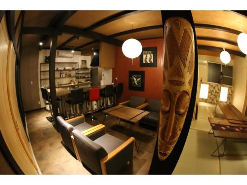 a living room with chairs and a table and a surfboard at Kishida House - Vacation STAY 36589v in Nagahama