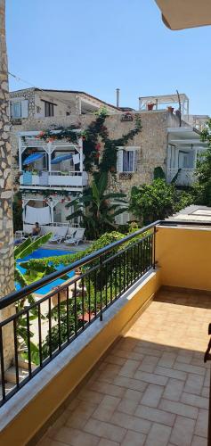 a balcony with a view of a building at Nicoll Apartments in Acharavi