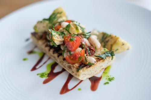 a piece of toast with vegetables on a white plate at Heathmount Hotel in Inverness