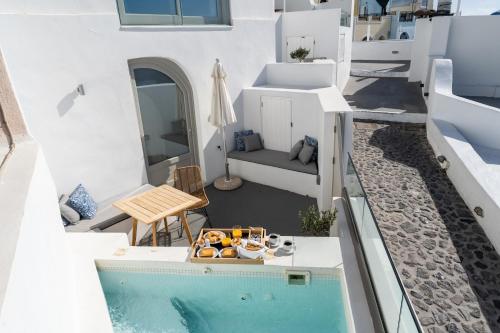 a villa with a swimming pool on a house at Smaro Studios in Firostefani