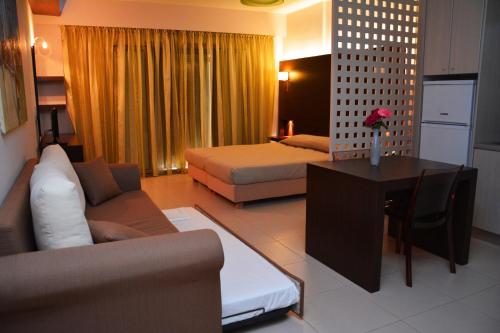 a living room with a couch and a bed at Tsokas Hotel in Finikounta
