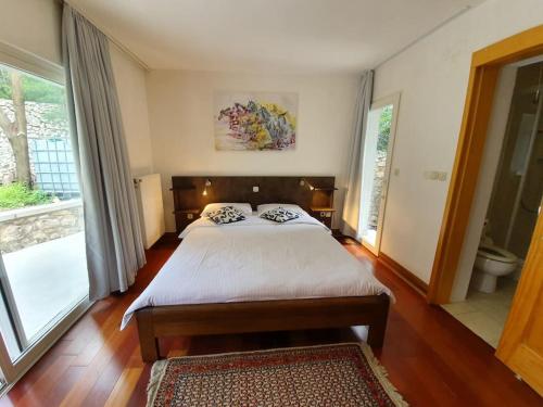 um quarto com uma cama grande e uma janela grande em Novi Escape em Novi Vinodolski