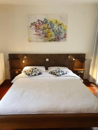 a bedroom with a bed with two pillows on it at Novi Escape 2 Beachfront 4 Star Apartment in Novi Vinodolski