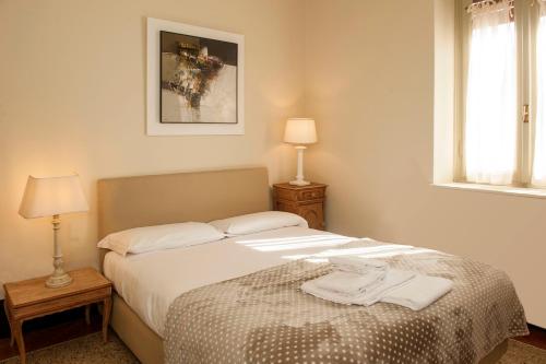 a bedroom with a bed with a robe on it at Villa Sofia in Sulzano